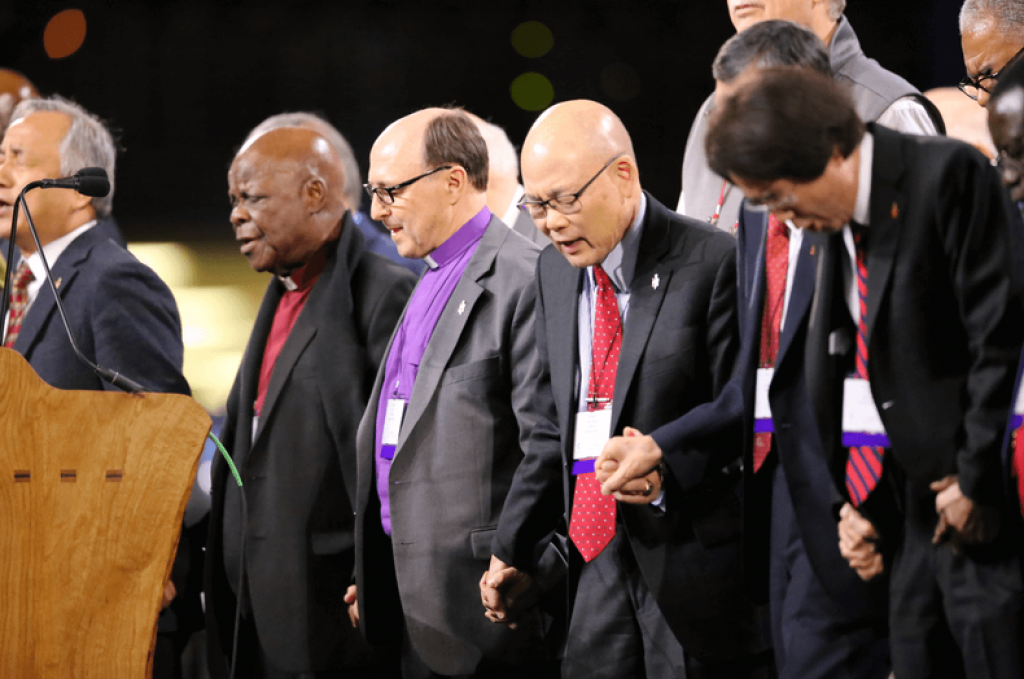 Bard praying with other bishops